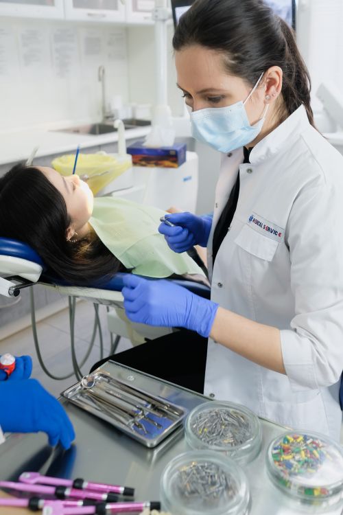 Dentist examining a cracked tooth root at a dental clinic in Aurora