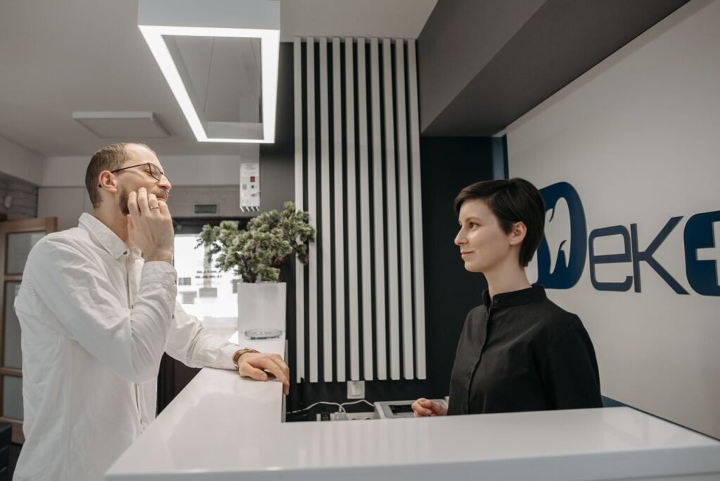 Receptionist at a dental clinic helping a patient with treatment payment options