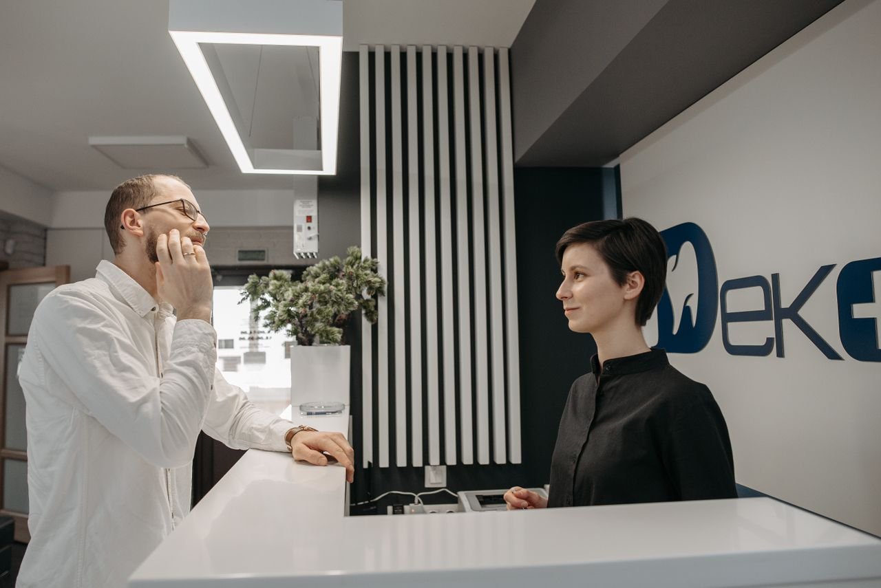 Receptionist at a dental clinic helping a patient with treatment payment options