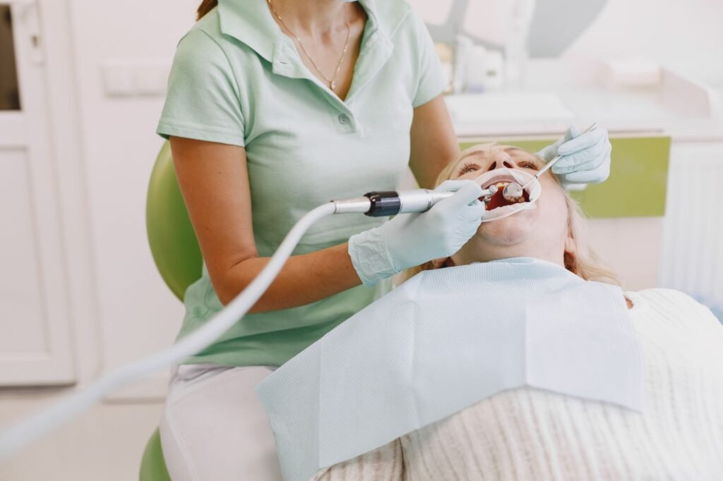 Dental hygienist performing a gentle teeth cleaning for a patient in Aurora